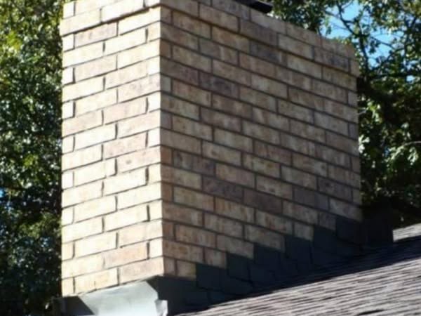 Completed rebuilt brick chimney with clean mortar joints