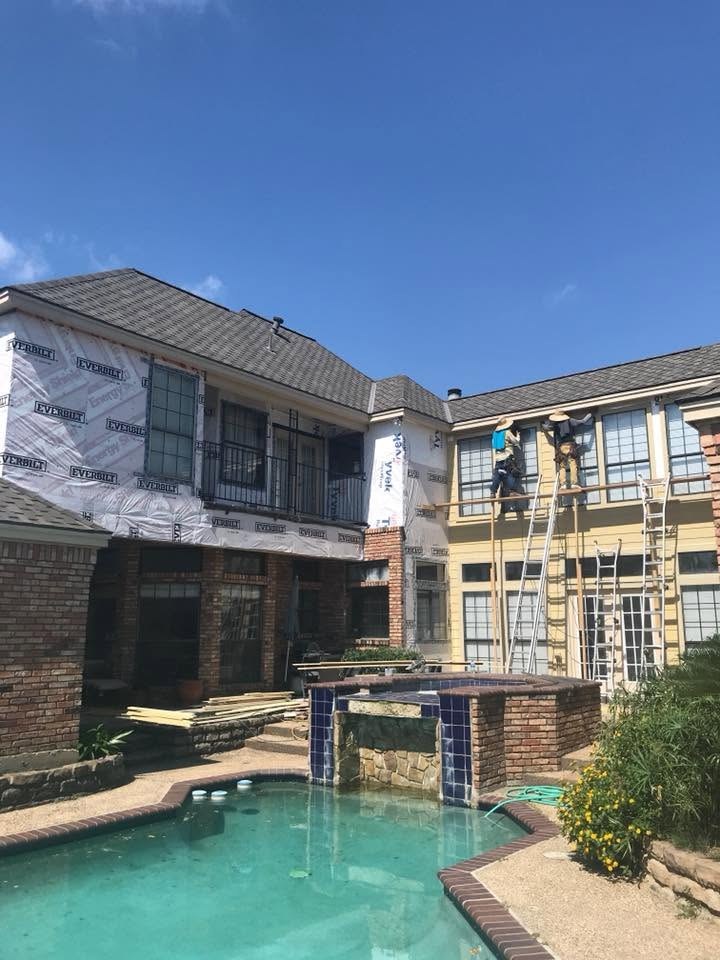 Crew working on the poolside elevation of an occupied multi-family property