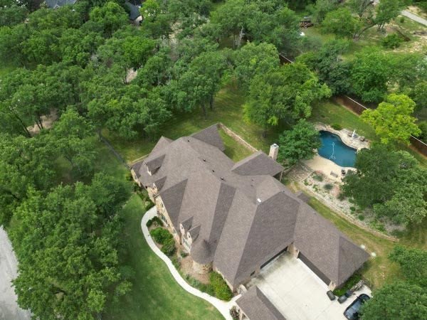 Aerial view of a full property during a roof inspection