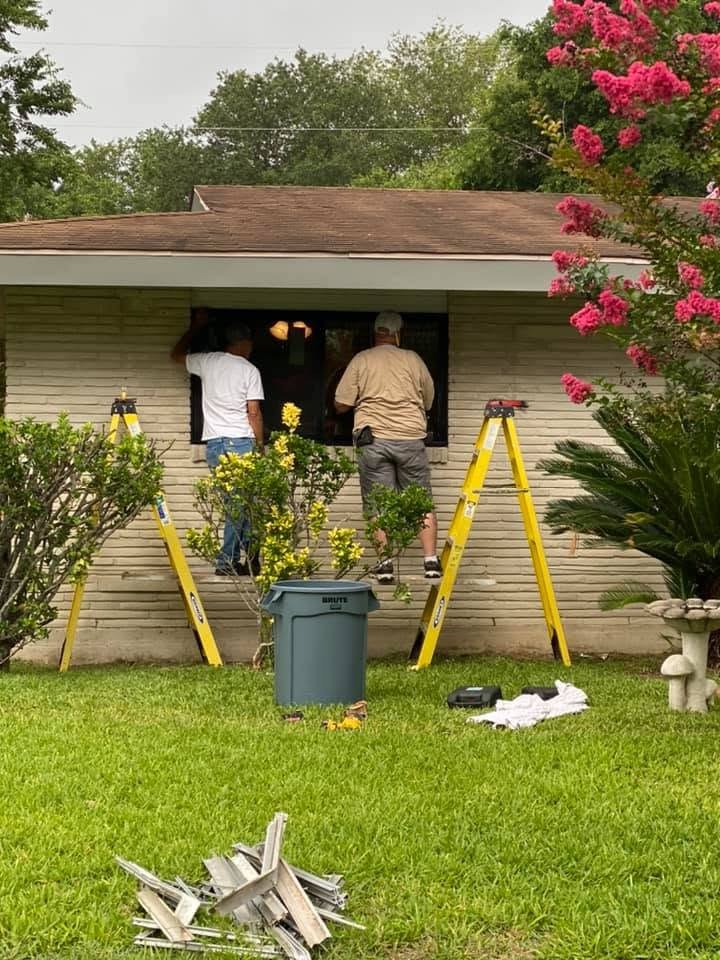 Mid Cities Roofing crew working at the front entry during a window and exterior replacement